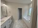 Main bathroom features dual sinks, quartz countertops, soaking tub, and hexagon-tile floors at 1008 Peedin Rd, Selma, NC 27576