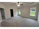 Spacious bedroom featuring plush carpet, a trey ceiling, two windows and a ceiling fan at 1008 Peedin Rd, Selma, NC 27576