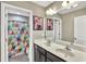 Bathroom with double vanity, framed mirrors and a colorful shower curtain at 1016 Leatherstone Ln, Fuquay Varina, NC 27526