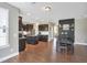 A kitchen and dining area shows dark cabinets, stainless appliances and wood flooring at 1016 Leatherstone Ln, Fuquay Varina, NC 27526