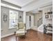 Cozy living room featuring stylish chair, wood floors, and staircase to the second floor at 1016 Leatherstone Ln, Fuquay Varina, NC 27526