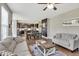 Spacious living room showcasing an open layout with hardwood floors, a dining area, and a comfortable seating area at 1016 Leatherstone Ln, Fuquay Varina, NC 27526