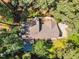 Aerial view of home surrounded by many mature trees and flowering azaleas at 108 Maplewood Dr, Knightdale, NC 27545