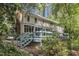Backyard view of home with screened in porch and large deck nestled amongst mature trees at 108 Maplewood Dr, Knightdale, NC 27545