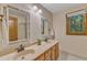 Bathroom with double sinks, stylish mirrors, and a view to the outside at 108 Maplewood Dr, Knightdale, NC 27545