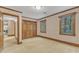Bedroom with neutral carpet, two large windows, and a double closet at 108 Maplewood Dr, Knightdale, NC 27545