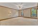 A large bedroom featuring two windows and neutral-colored carpet at 108 Maplewood Dr, Knightdale, NC 27545