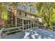 View from deck to home's screened in porch surrounded by mature trees at 108 Maplewood Dr, Knightdale, NC 27545