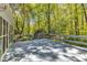 Wide view of large wood deck surrounded by mature trees at 108 Maplewood Dr, Knightdale, NC 27545