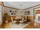 Decorated dining room featuring a wooden table, upholstered chairs, and decorative wall art creating a cozy atmosphere at 108 Maplewood Dr, Knightdale, NC 27545