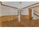 Traditional dining room featuring hardwood floors, classic wainscoting, and a chandelier adding charm and elegance at 108 Maplewood Dr, Knightdale, NC 27545