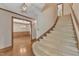 Welcoming entryway featuring a curved staircase and a view of a dining room with elegant lighting at 108 Maplewood Dr, Knightdale, NC 27545