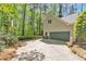 Home's exterior with a garage, surrounded by lush green trees, and a driveway at 108 Maplewood Dr, Knightdale, NC 27545