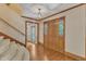 Inviting foyer featuring hardwood floors, elegant staircase, and decorative wood doors creating a warm welcome at 108 Maplewood Dr, Knightdale, NC 27545