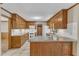 Updated kitchen featuring wooden cabinets, granite countertops, and modern white appliances at 108 Maplewood Dr, Knightdale, NC 27545