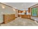 Spacious kitchen with wooden cabinets, tile floors, and a view of the trees outside at 108 Maplewood Dr, Knightdale, NC 27545