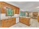 Charming kitchen with wood cabinets, granite countertops and stainless steel sink under a window providing natural light at 108 Maplewood Dr, Knightdale, NC 27545