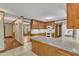 Open kitchen area with granite countertops, wooden cabinets and seamless flow to the dining area at 108 Maplewood Dr, Knightdale, NC 27545