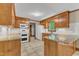 Updated kitchen featuring wooden cabinets, granite countertops, and stainless-steel appliances at 108 Maplewood Dr, Knightdale, NC 27545
