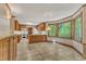 Well-lit kitchen with wooden cabinets, modern white appliances, and a scenic window view at 108 Maplewood Dr, Knightdale, NC 27545