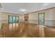 Spacious living room with hardwood floors, brick fireplace, and natural light from a large window and sliding glass doors at 108 Maplewood Dr, Knightdale, NC 27545