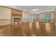 An open living room featuring a brick fireplace, hardwood flooring and multiple windows offering natural light at 108 Maplewood Dr, Knightdale, NC 27545