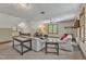 Bright living room with a cozy seating area, large windows, and a warm color palette at 108 Maplewood Dr, Knightdale, NC 27545