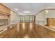 Inviting living room featuring hardwood floors, a cozy brick fireplace, and sun-filled windows at 108 Maplewood Dr, Knightdale, NC 27545