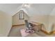 Attic office space with a desk and chair, with natural light from the window at 108 Maplewood Dr, Knightdale, NC 27545