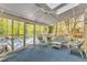 Comfortable sun room with multiple places to sit with a wooded outdoor view at 108 Maplewood Dr, Knightdale, NC 27545