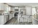 Stylish kitchen features modern appliances, granite countertops, and an island with seating at 11 Artesa Ct, Fuquay Varina, NC 27526