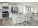 Bright kitchen with stainless steel appliances, a granite island, and an open view to the living area at 11 Artesa Ct, Fuquay Varina, NC 27526