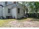 Exterior backyard, showing the brick, as well as the back door and AC unit at 1106 Sycamore St, Rocky Mount, NC 27801