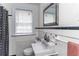 Classic bathroom with tile surround, black accent stripe, and a black and white shower curtain at 1106 Sycamore St, Rocky Mount, NC 27801