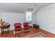 Bedroom featuring hardwood floors, two red upholstered chairs and lots of light at 1106 Sycamore St, Rocky Mount, NC 27801