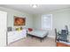 Bedroom with a light blue bed, white dresser, and wall art to brighten the space at 1106 Sycamore St, Rocky Mount, NC 27801