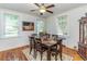 Dining room with hardwood floors, bright windows, and a formal dining table at 1106 Sycamore St, Rocky Mount, NC 27801