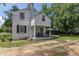 Side view of a two-story home featuring a screened-in porch and landscaped yard at 1106 Sycamore St, Rocky Mount, NC 27801