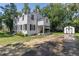 Back of house featuring a white brick exterior, a covered porch, and a shed at 1106 Sycamore St, Rocky Mount, NC 27801