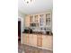 Kitchen counter with light wood cabinets, ample counter space and glass front storage at 1106 Sycamore St, Rocky Mount, NC 27801