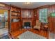Classic living room showcases hardwood floors, wood paneling, fireplace, and a cozy chair at 1106 Sycamore St, Rocky Mount, NC 27801