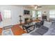 Bright living room featuring a fireplace, large sectional sofa, and hardwood floors at 1106 Sycamore St, Rocky Mount, NC 27801