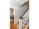 View of a staircase with wooden banister and dining room visible through open door at 1106 Sycamore St, Rocky Mount, NC 27801