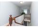 Traditional stairwell with wooden railing, white balusters, and natural light at 1106 Sycamore St, Rocky Mount, NC 27801