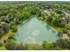 Picturesque aerial view of a serene pond surrounded by lush greenery and neighborhood homes at 112 Natchez Ct, Cary, NC 27519