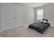 Bedroom featuring neutral carpeting, a large window, and a spacious closet at 112 Natchez Ct, Cary, NC 27519
