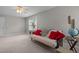 This bedroom features neutral carpet and trim, window with natural light, ceiling fan, and couch at 112 Natchez Ct, Cary, NC 27519