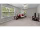 Spacious bedroom with windows and a sitting area, illuminated by a ceiling fan at 112 Natchez Ct, Cary, NC 27519