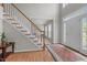 Bright foyer boasts hardwood floors, a staircase, and an abundance of natural light at 112 Natchez Ct, Cary, NC 27519