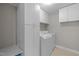 Bright laundry area features modern washer, dryer, and plenty of white cabinets for organized storage at 112 Natchez Ct, Cary, NC 27519